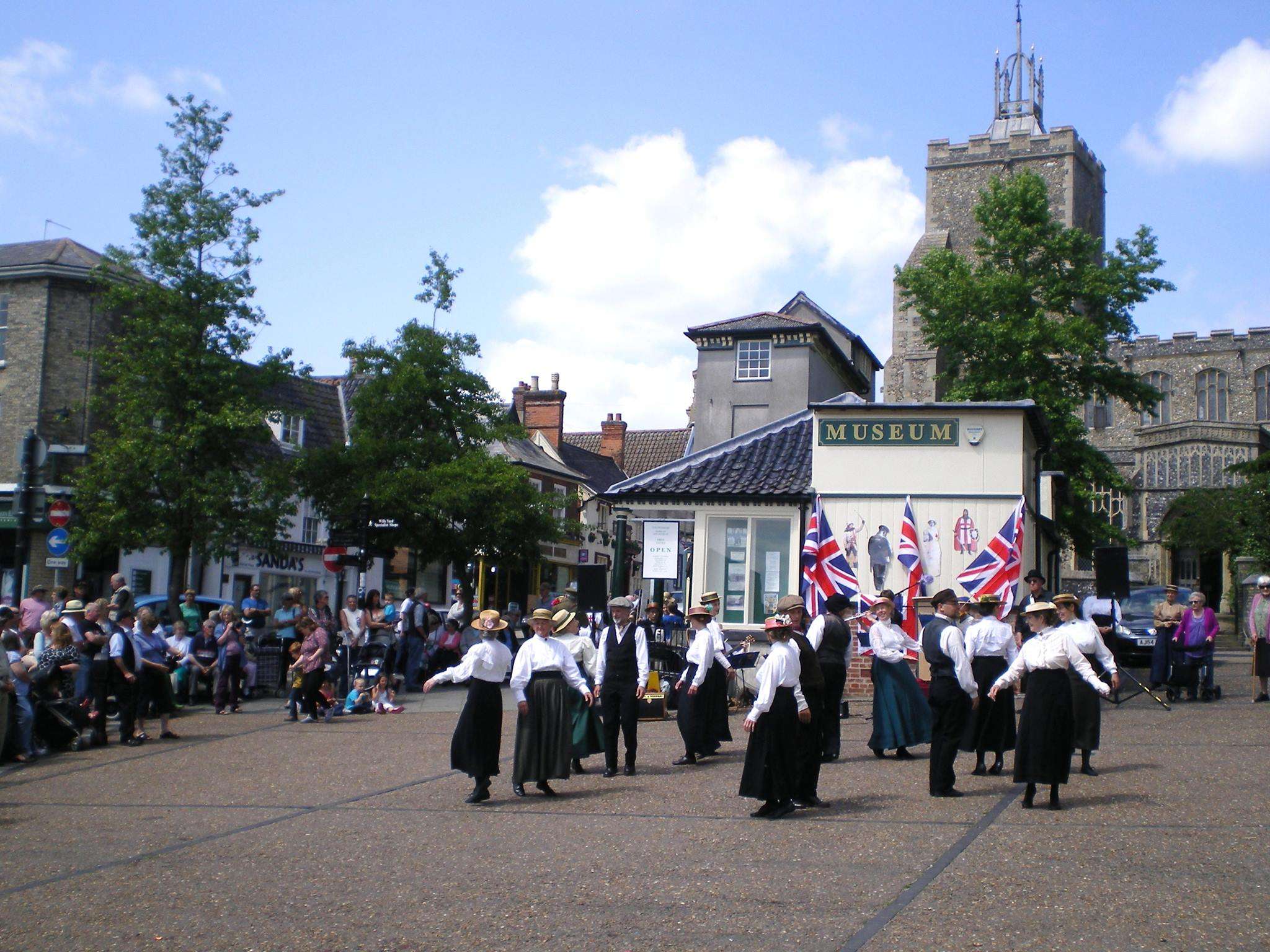 Visitors gathering outside Diss Museum to watch dancers in period dress.