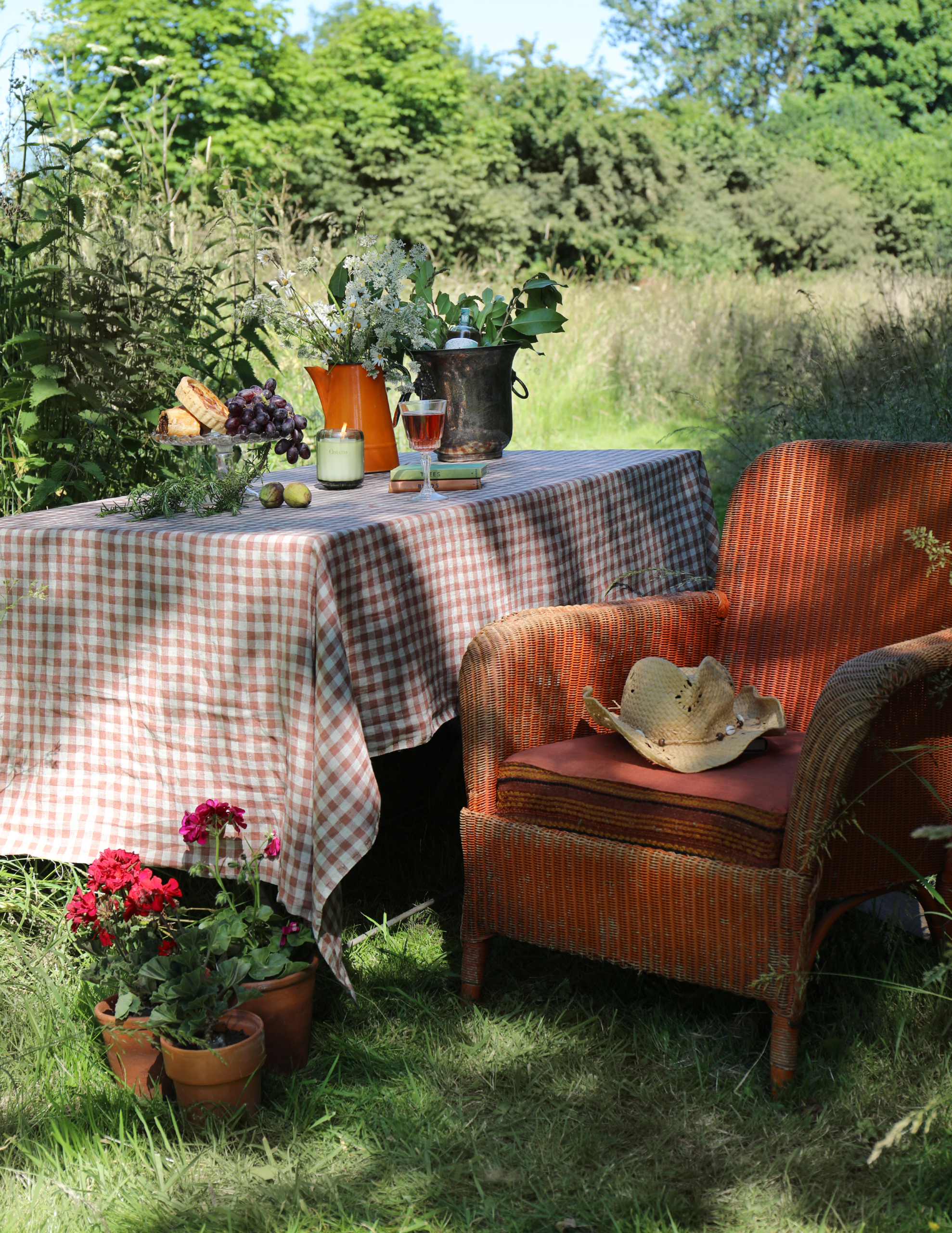 Outdoor seating area with table and chairs overlooking a natural waterside setting.