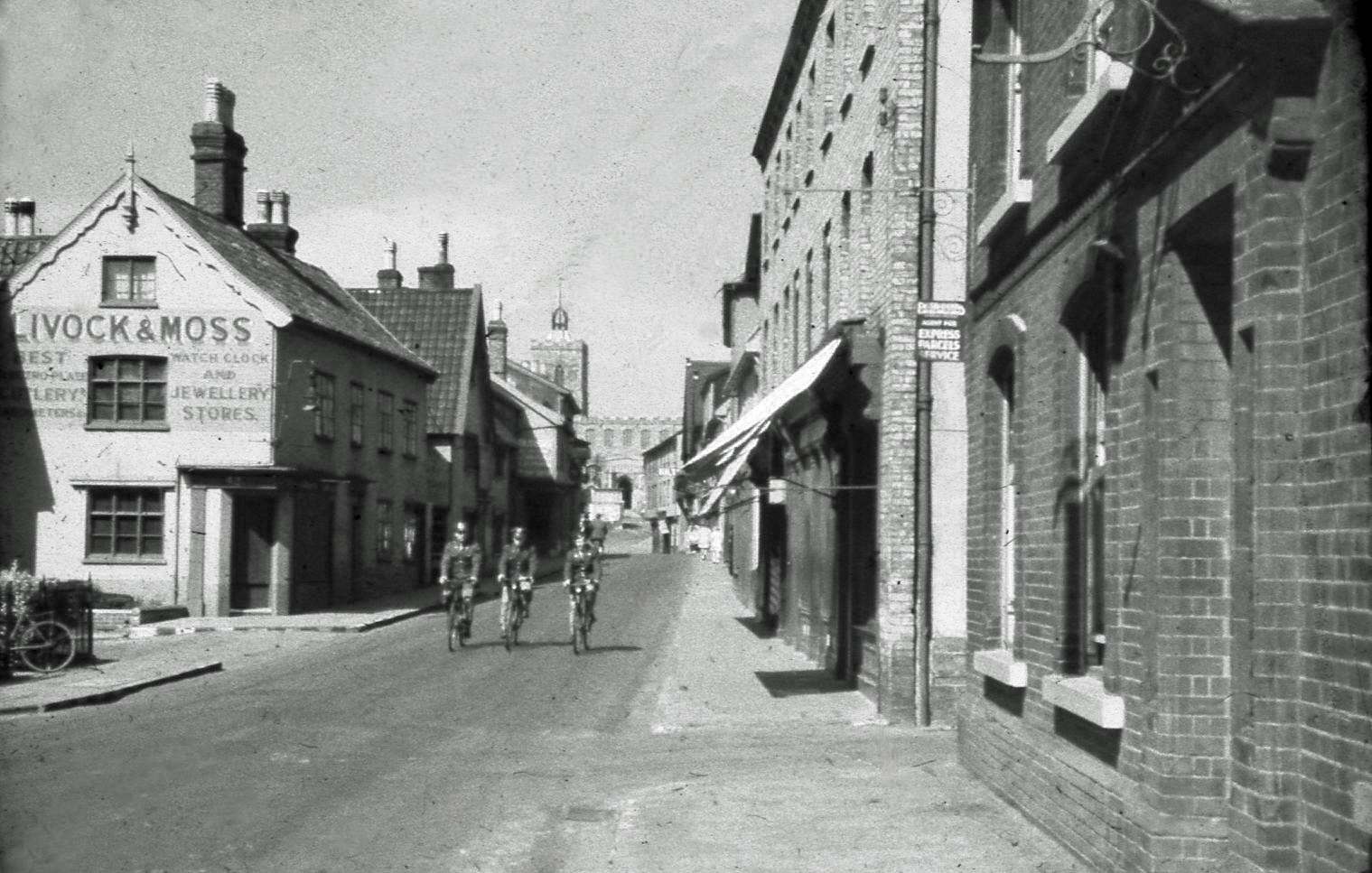 Historic view of Mere Street in Diss showing traditional shopfronts.