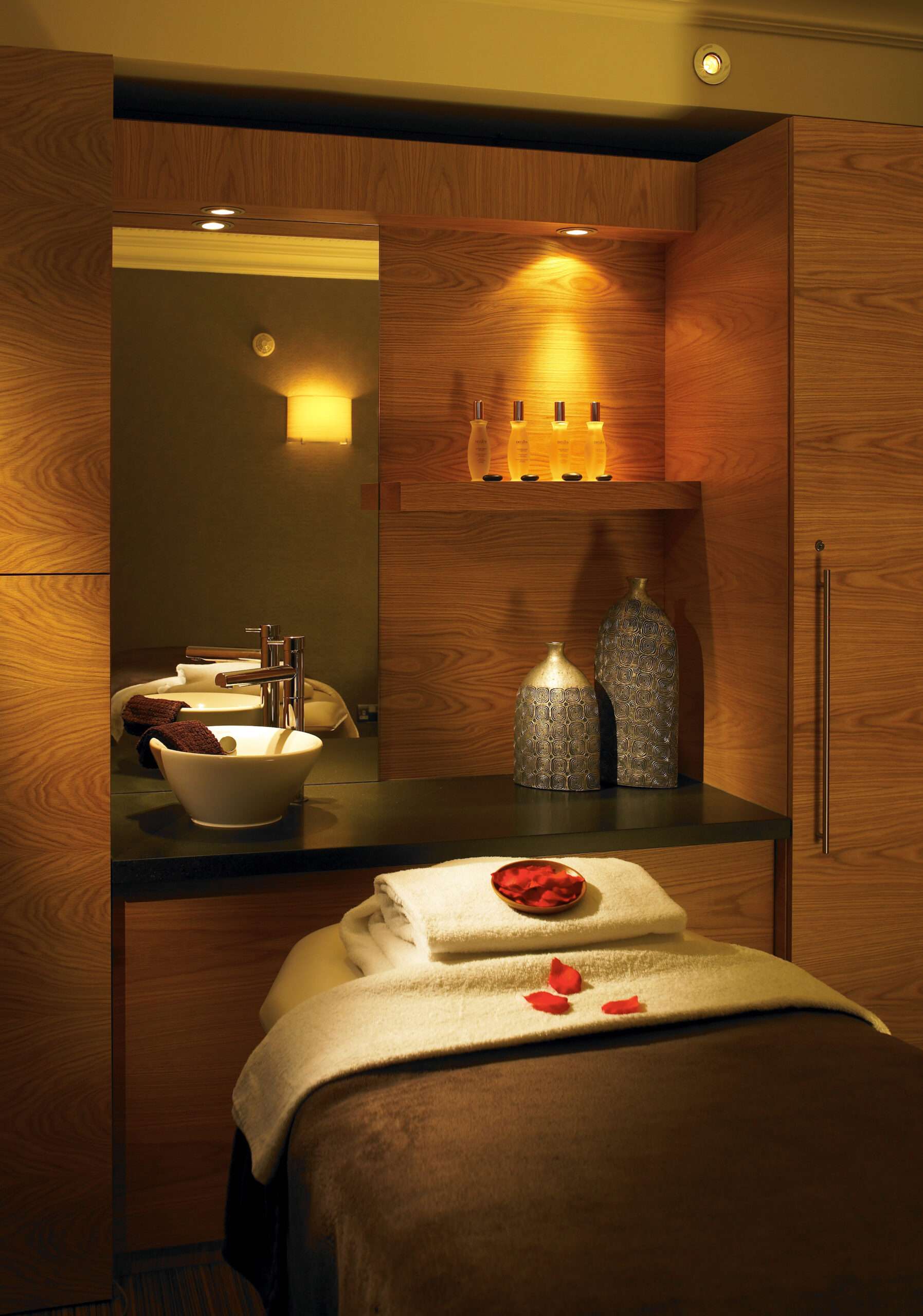 Sprowston Manor Luxury spa treatment room featuring soft lighting and contemporary décor.