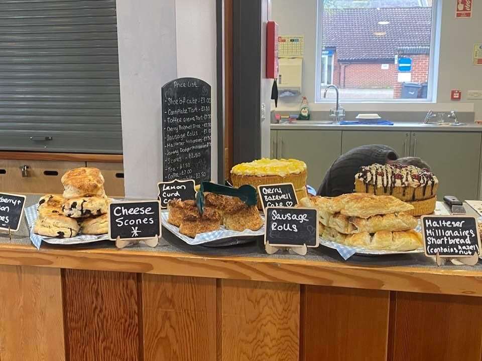 Display of freshly baked sausage rolls, cheese scones and homemade cakes available at The Hideout.