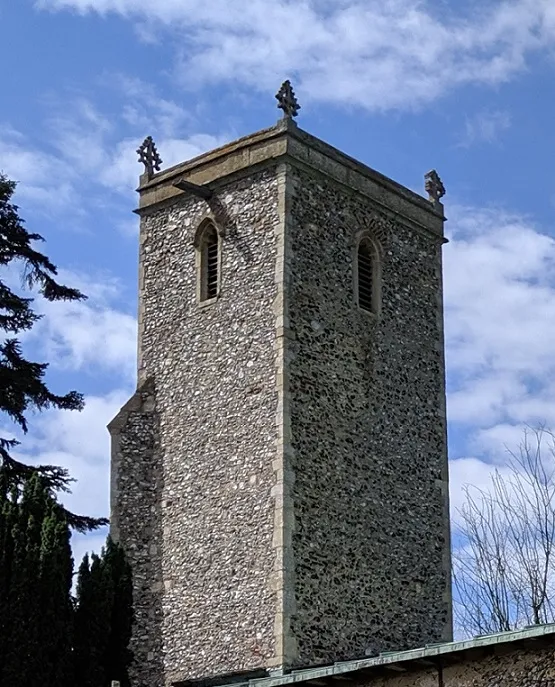 Historic church tower rising above the surrounding landscape in Norfolk.