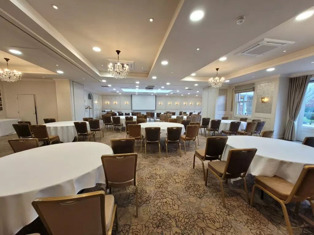 Elegant restaurant dining room set for guests at Park Farm Hotel.