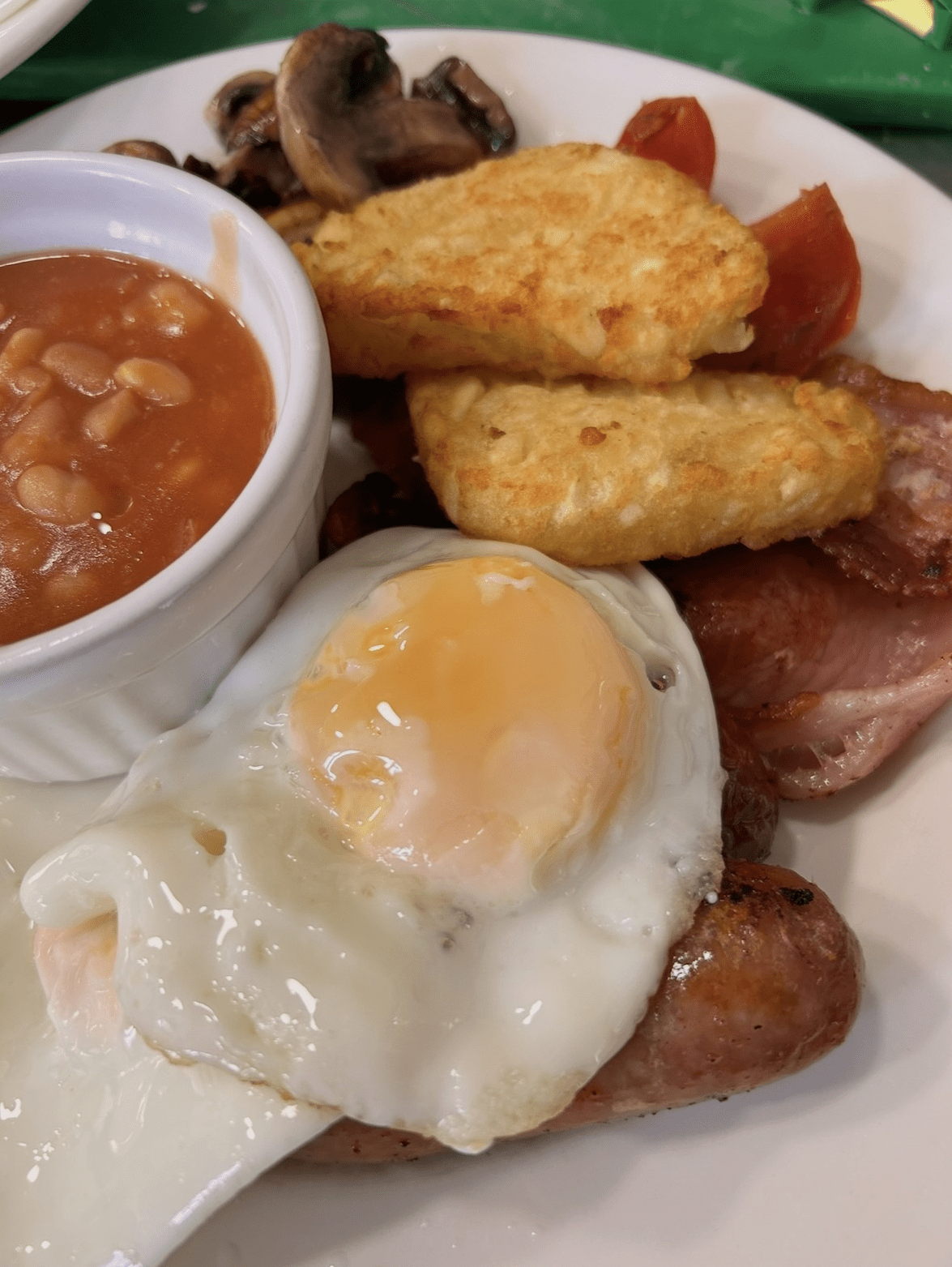 Cooked breakfast with bacon, egg, hash browns and baked beans served at A Piece of Cake, Coltishall.