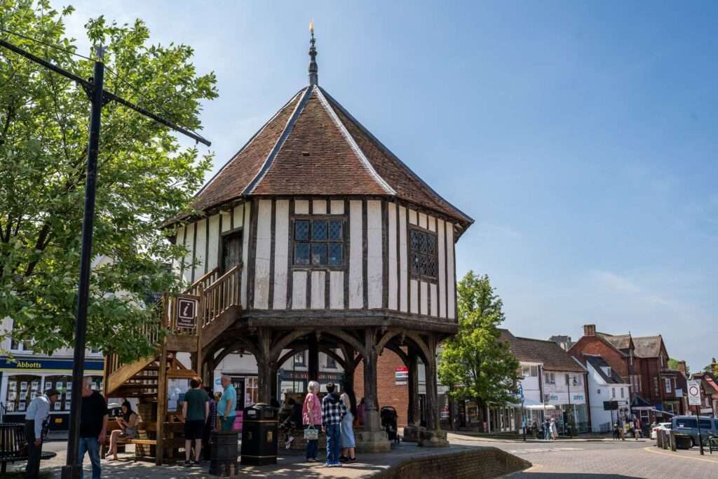 The historic Market Cross landmark in Wymondham against a bright blue sky.