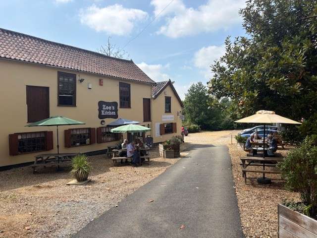 Exterior view of Zoe's café with outdoor seating in Diss